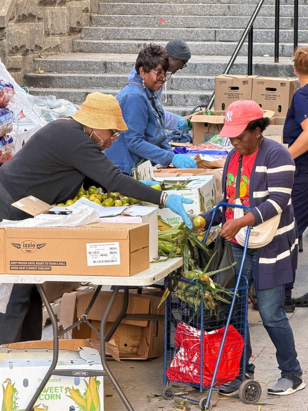 NGBM volunteers distributing fresh produce at a food pantry giveaway
