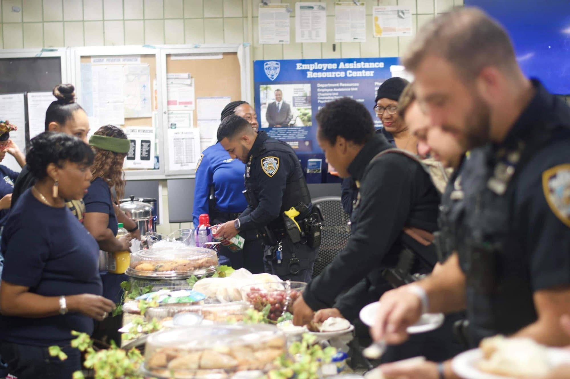 NGBM members and NYPD officers sharing a meal at an Adopt-a-Precinct event