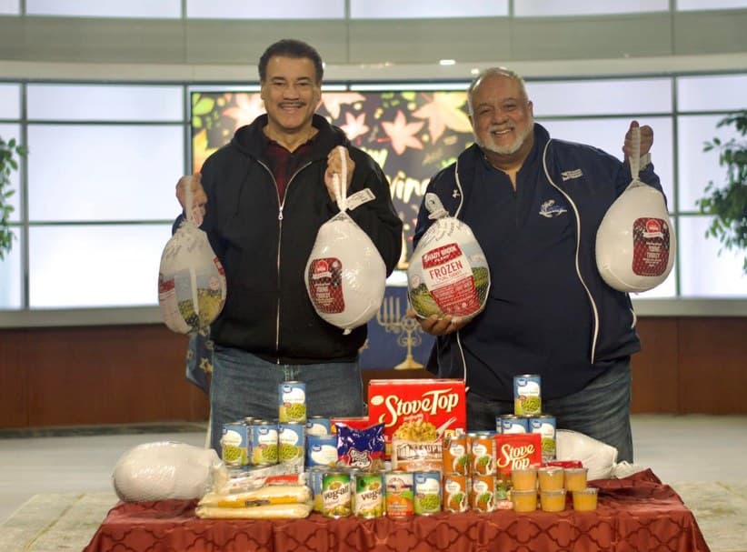 NGBM leadership presenting Thanksgiving turkeys and canned goods for community distribution